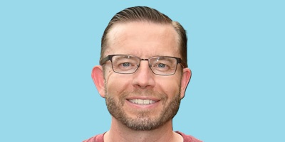 Close up image of Mike with a blue rectangular background